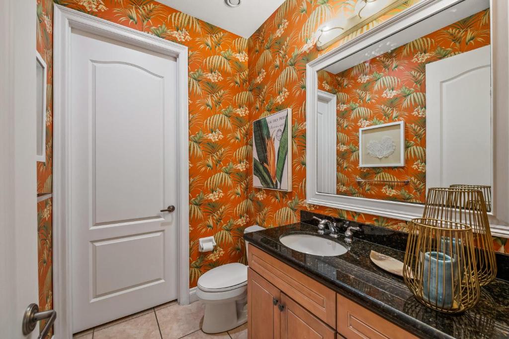 Refresh in your own vibrant tropical retreat where bold botanical wallpaper and polished granite counters create an energizing yet sophisticated escape.