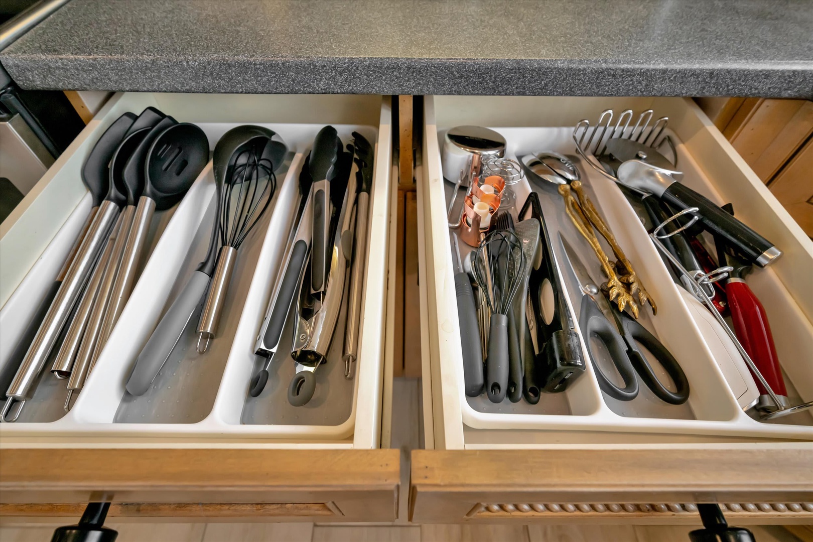 Your kitchen is stocked with all the essentials, from whisks and tongs to a can opener and scissors, neatly organized so you can cook with ease.