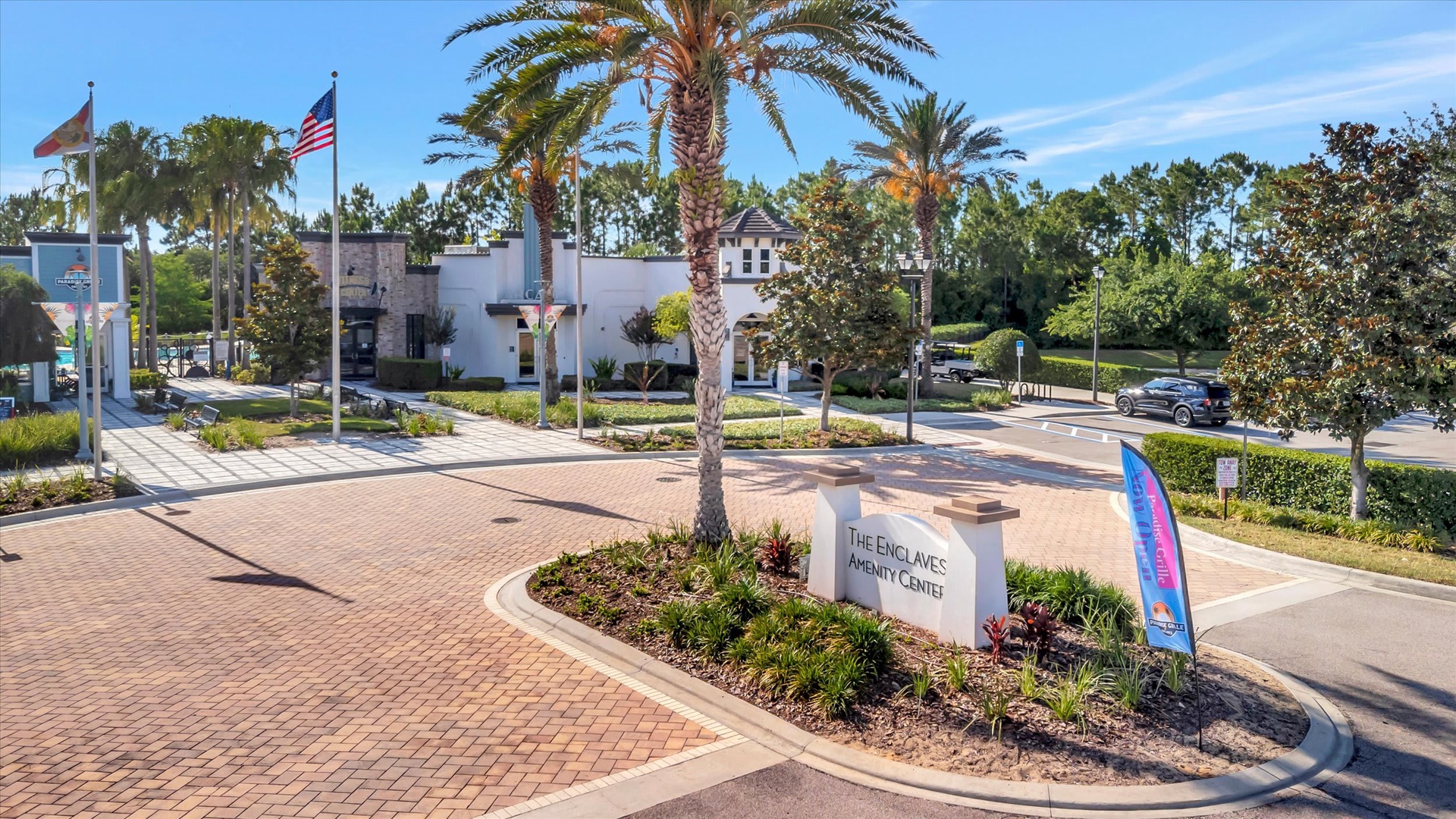 The Enclaves Amenity Center serves as the heart of this community, featuring landscaped grounds with palm trees and well-maintained walkways that welcome residents and guests.