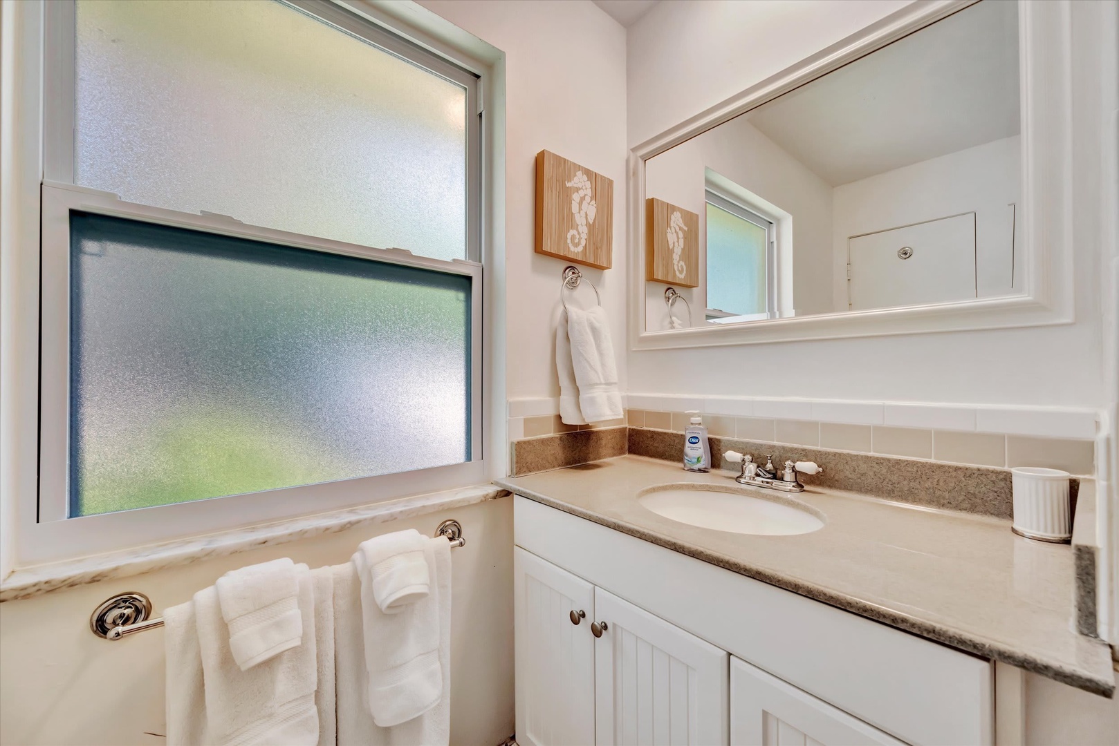 Step into your spotless bathroom featuring a soaking tub, vanity with ample counter space, and fresh towels waiting for you—a peaceful spot to unwind after a day of adventure.