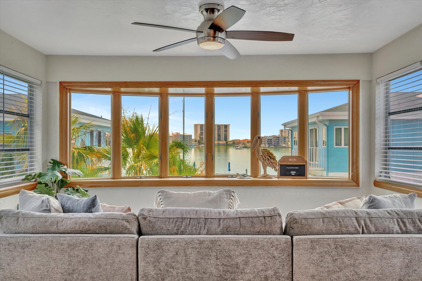 Relax in your inviting living room while enjoying sweeping water views through expansive windows. The coastal breeze and natural light create a perfect retreat for unwinding after a day of exploring.
