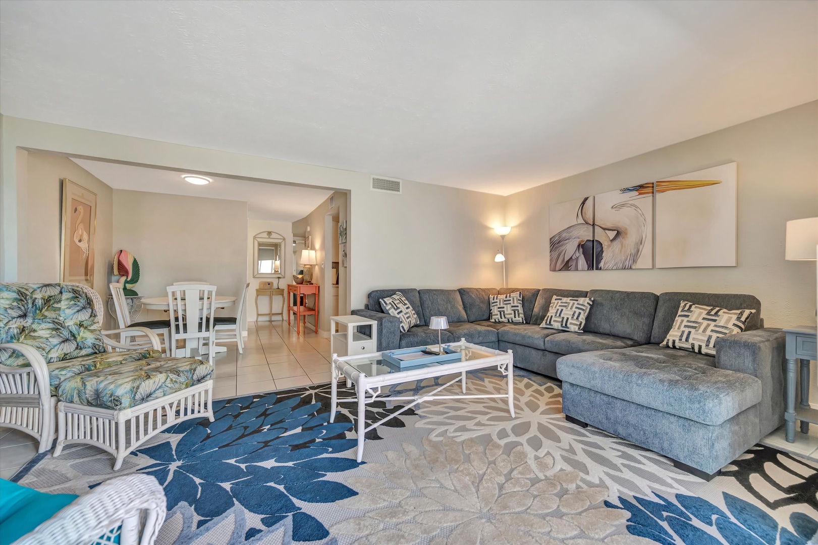 Settle into your spacious living room with plush seating and coastal-inspired décor, where natural light and an open layout invite you to unwind after a day at the beach.