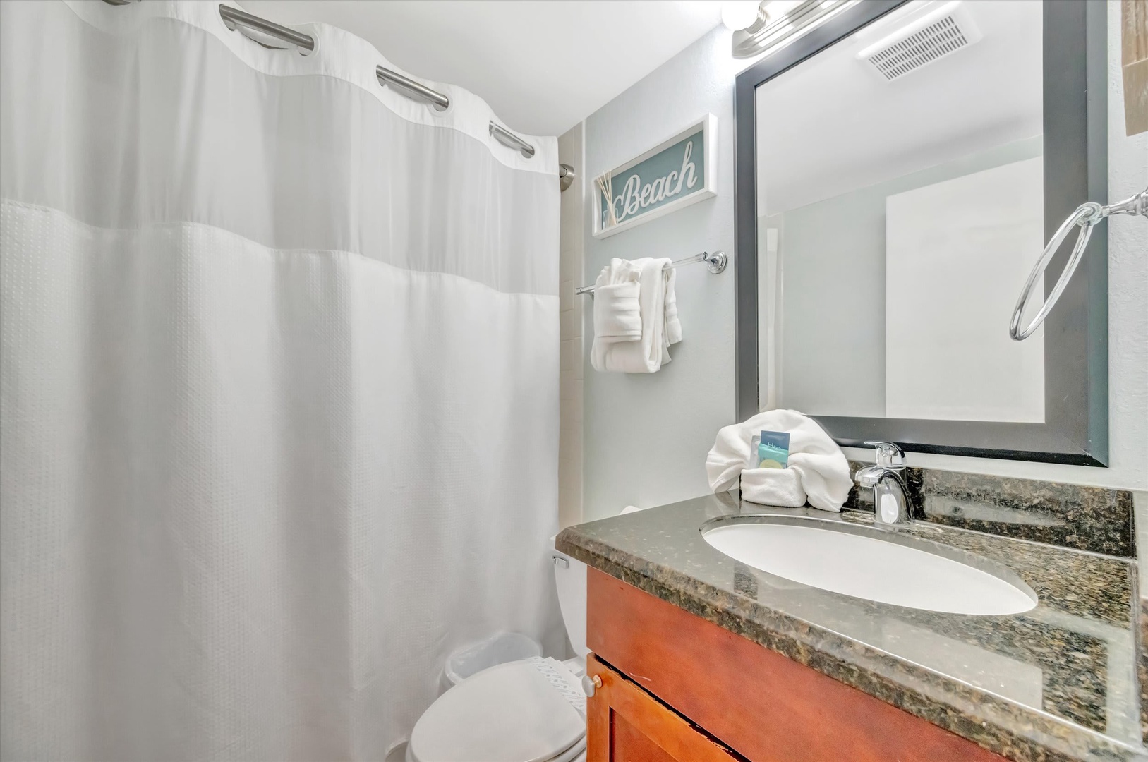 Step into your freshly cleaned bathroom, where crisp white towels and coastal-inspired details welcome you after a day of adventure.
