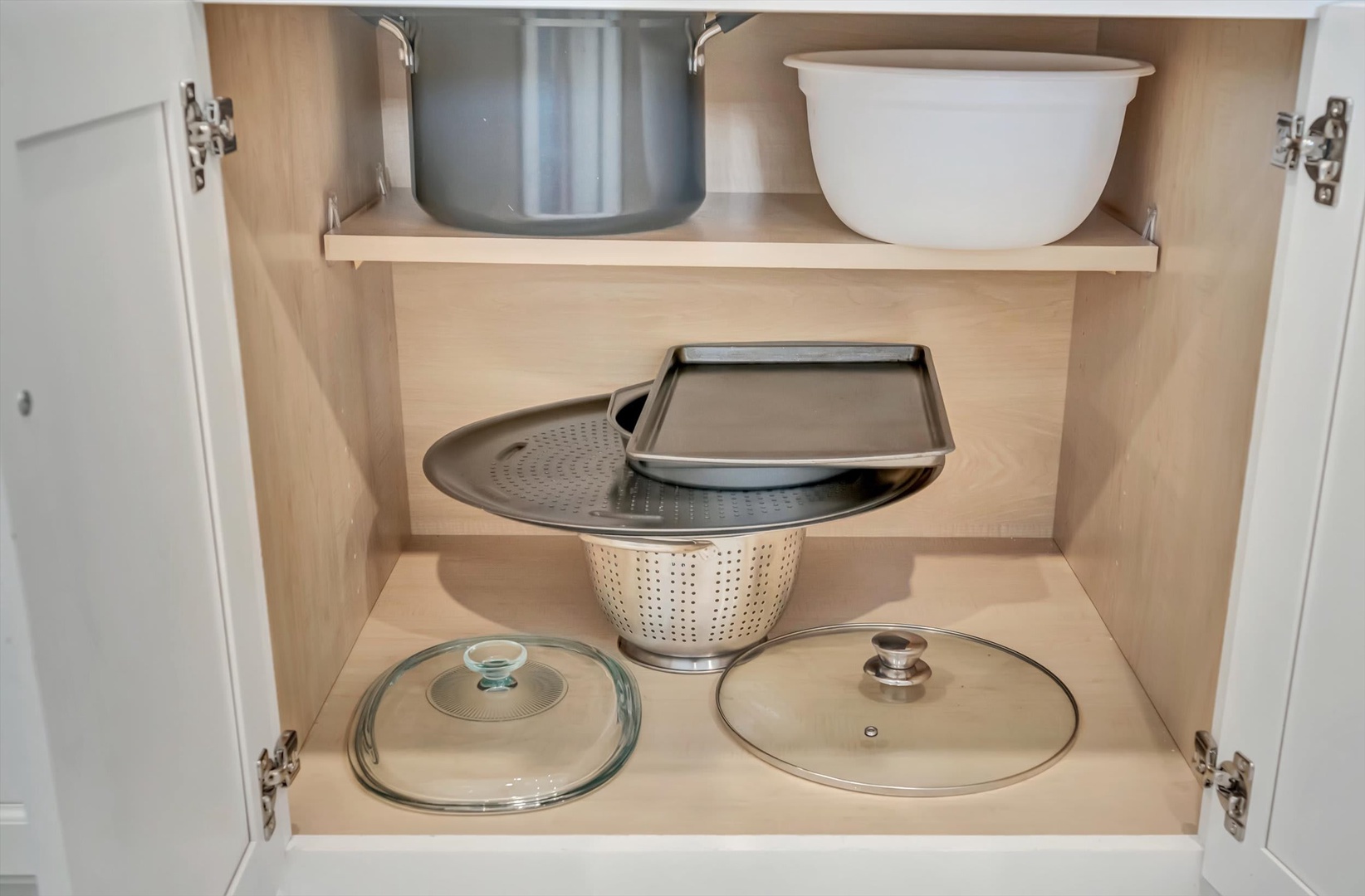 Your kitchen is fully equipped with everything you'll need, from cookware to serving pieces—all neatly organized and ready for you to whip up delicious meals.