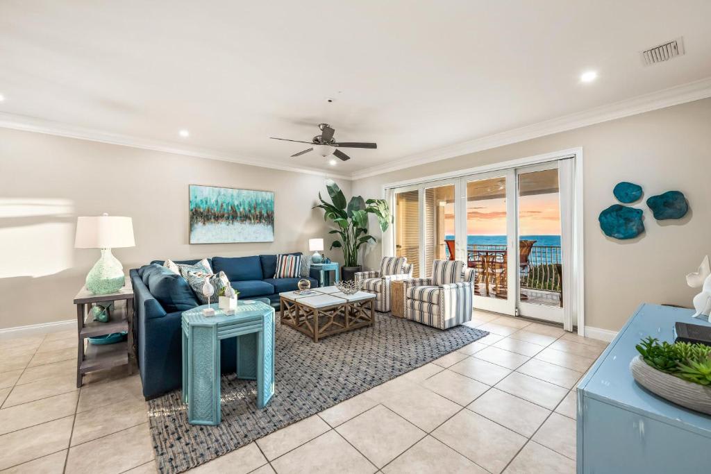 Sink into plush seating and enjoy ocean views through your private balcony doors. Cool coastal tones and breezy comfort make this your perfect retreat after a day at the beach.