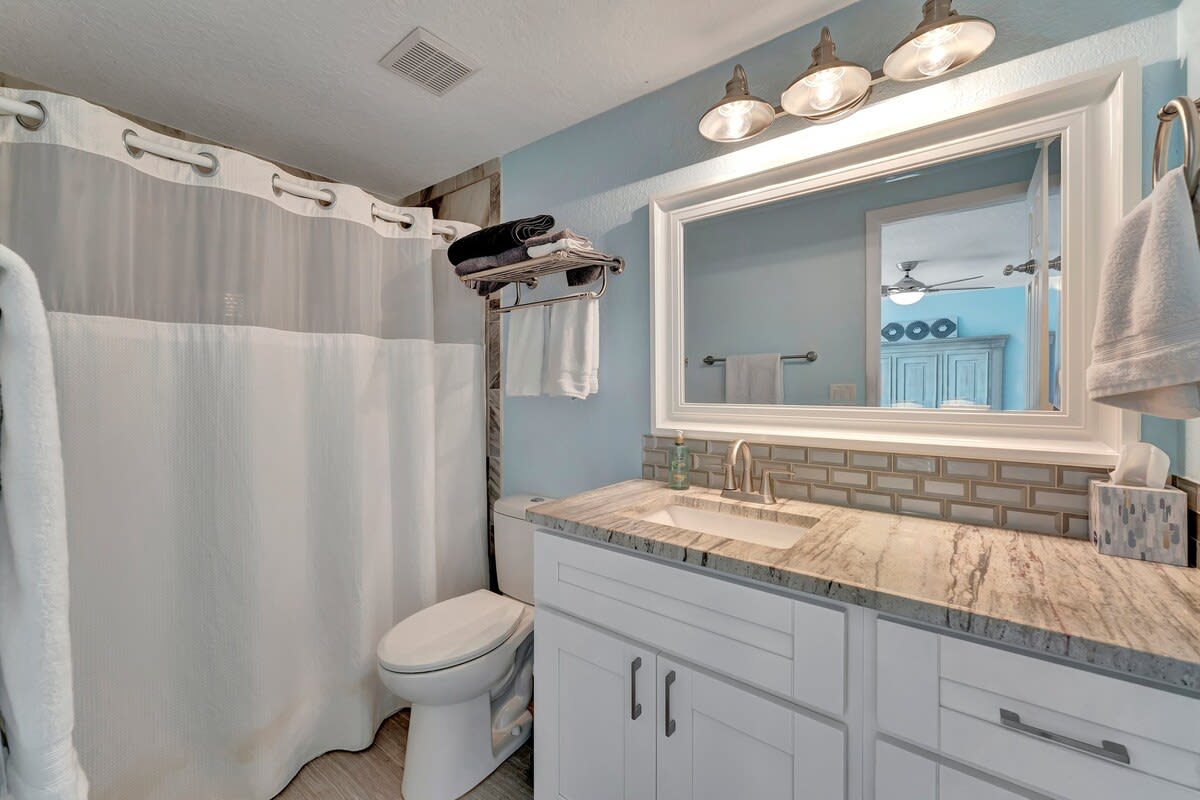 Step into your beautifully updated bathroom with calming coastal hues, elegant marble countertops, and subway tile accents that make every morning feel refreshing and rejuvenating.