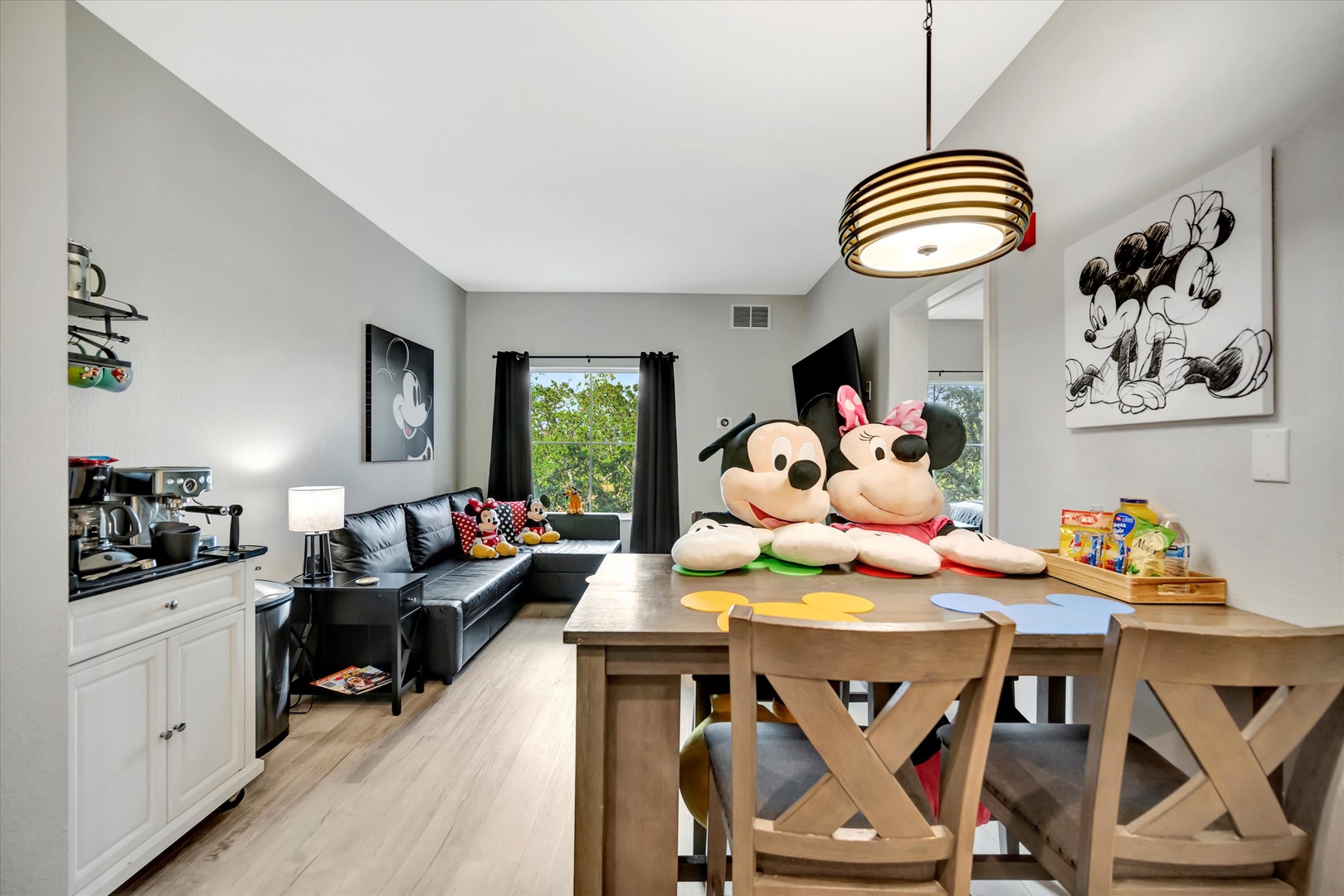 Step into your Disney-themed haven where Mickey and Minnie welcome you home. Gather around the dining table for family meals, unwind on the cozy sofa, and enjoy your favorite shows in this playful retreat.