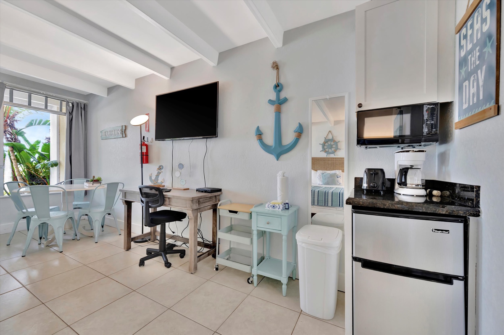 Coastal charm meets convenience—your bright retreat features a kitchenette with essentials, a breezy dining spot, and relaxing beach-inspired touches throughout.