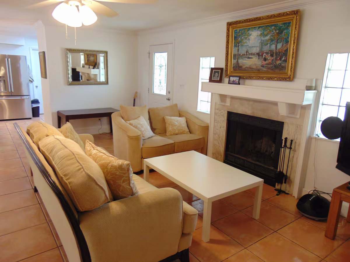 Gather in your bright, welcoming living room with comfortable seating and a cozy fireplace for relaxing evenings together.