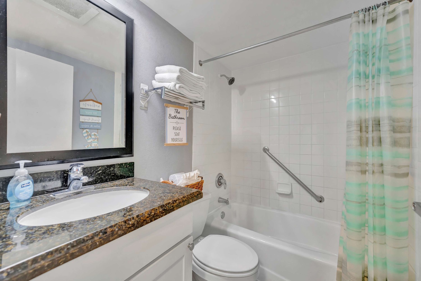 Your private bathroom features a spacious tub-shower combo, fresh towels, and a granite vanity with a large mirror—everything you need to unwind after a day of adventure.