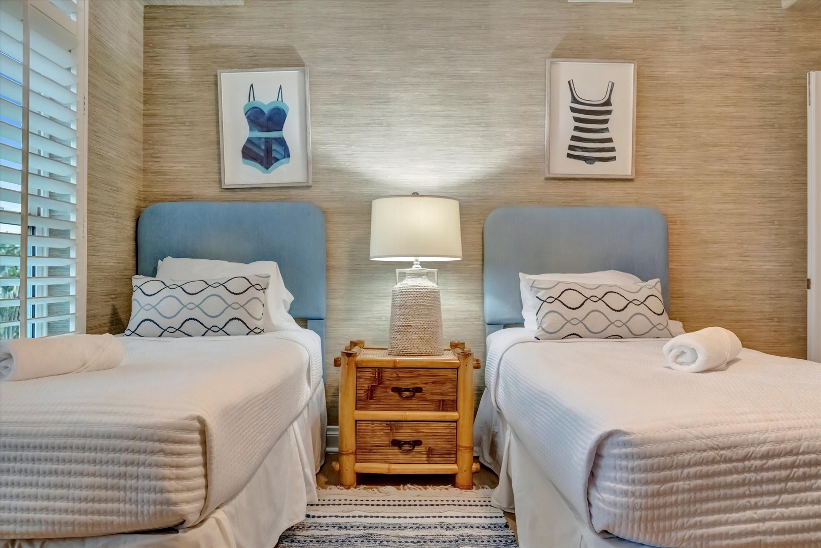 Unwind in your coastal-inspired retreat, where two comfy twin beds and playful vintage beach prints create the perfect spot for relaxation after a sun-filled day.
