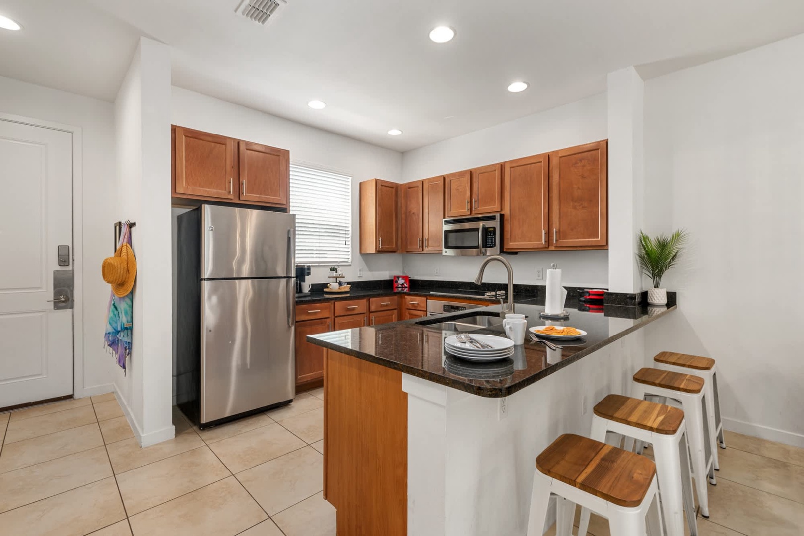 Your bright, open kitchen welcomes you with sleek stainless steel appliances, granite countertops, and a breakfast bar perfect for morning coffee or casual meals.