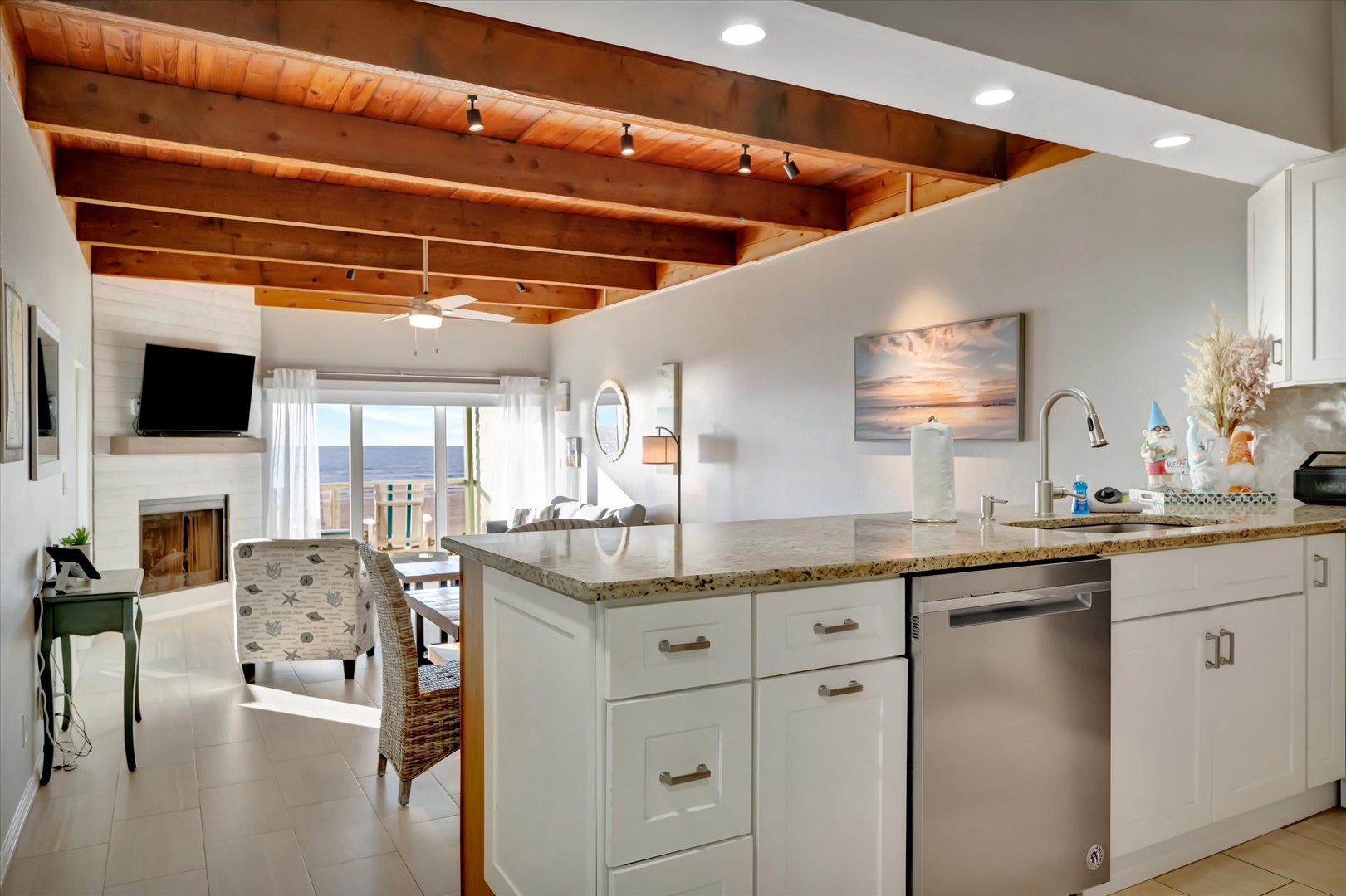 Open your window and take in the stunning ocean view from this bright, airy space. The vaulted wood ceilings and coastal-chic design invite you to unwind, cook together, and savor every moment by the sea.