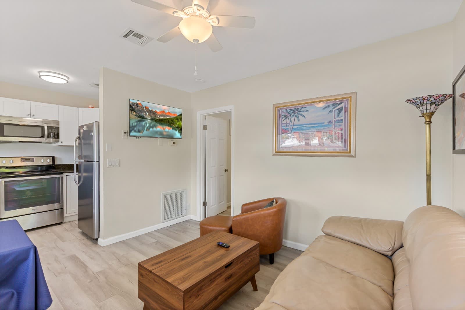 Kick back in your bright, open living space with contemporary furnishings and a ceiling fan to keep you cool. The fully equipped kitchen is steps away—perfect for easy meal prep.