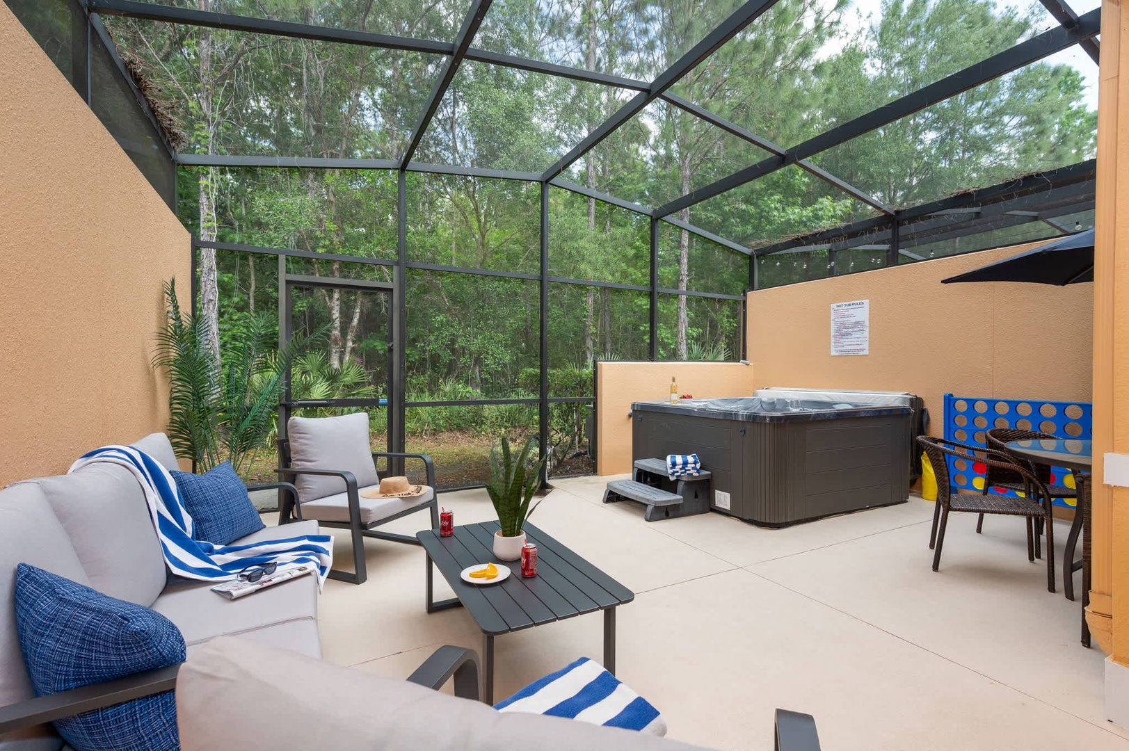 Step into your private screened patio, where a hot tub and outdoor games set the stage for relaxation. Lounge with morning coffee or unwind under the evening sky as nature surrounds you.
