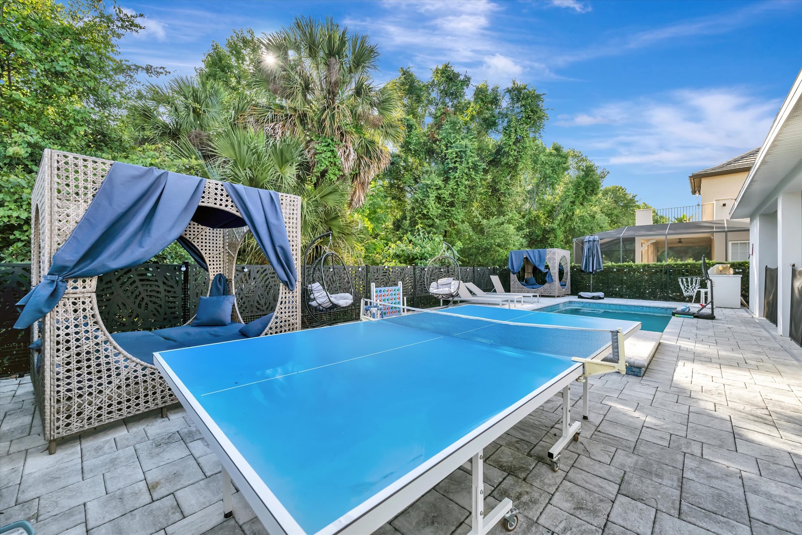Challenge friends to a match or lounge in the shaded seating while soaking up the tropical backyard vibe. The pool awaits just beyond for cooling off afterward.
