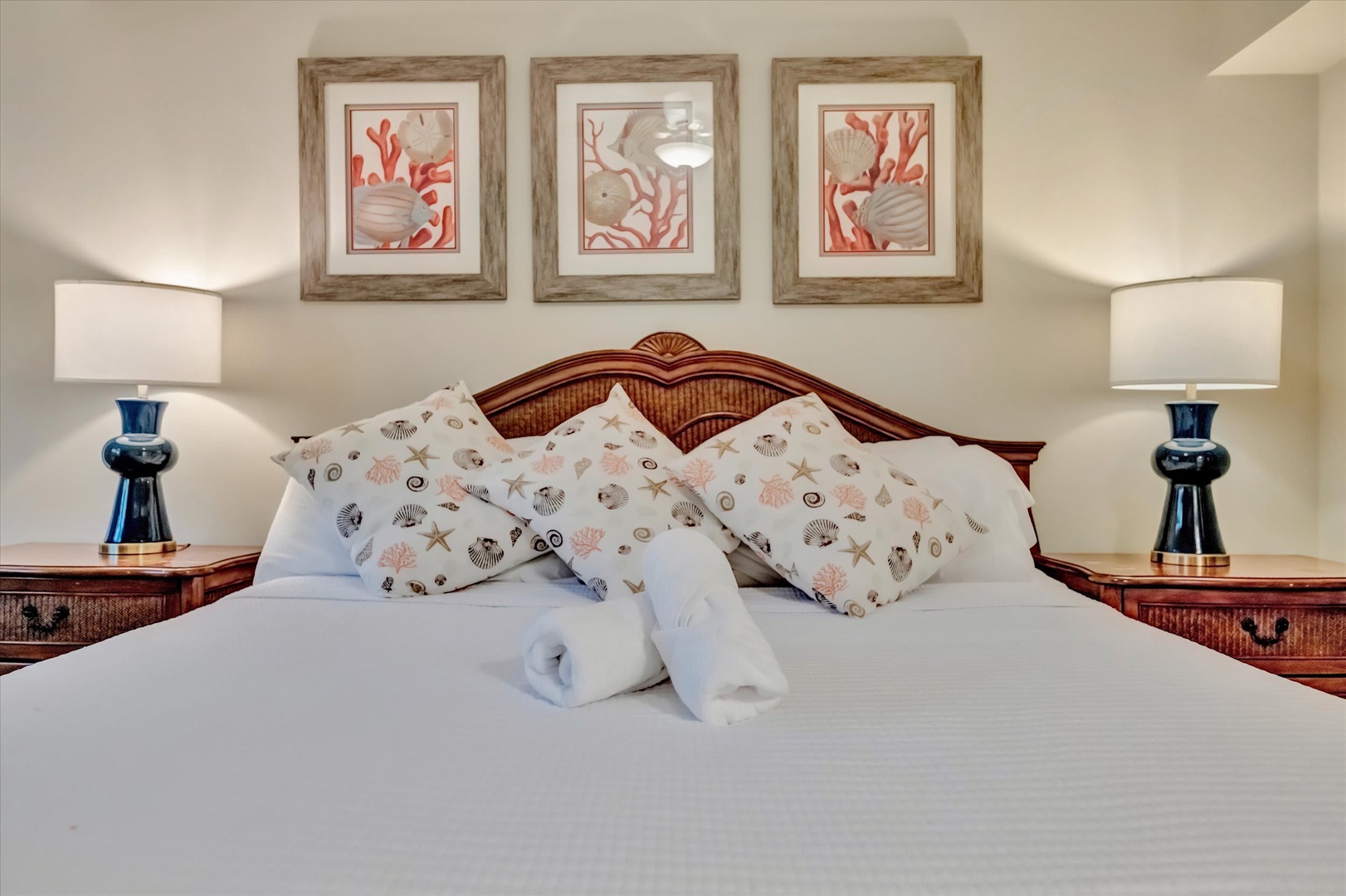 Drift off in this coastal-inspired bedroom where fresh linens and thoughtful details create your peaceful retreat. The beach-themed decor and plush towels set the tone for your seaside escape.