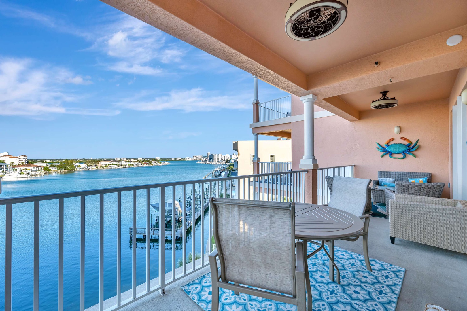 Sip your morning coffee while soaking in sweeping waterfront views from this private balcony, where vibrant blue waters and coastal scenery create the perfect backdrop for relaxation.