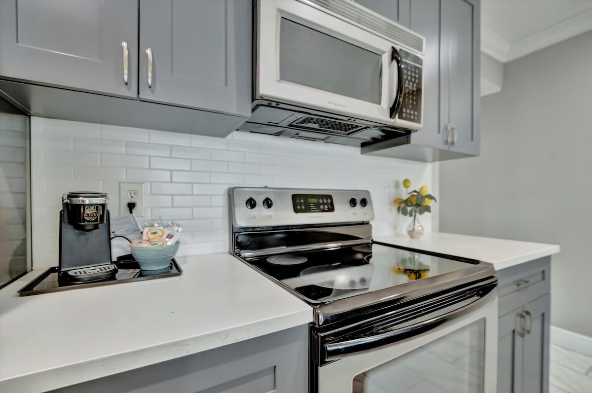Step into your bright, fully equipped kitchen with sleek countertops and modern appliances ready for your morning coffee ritual or preparing a home-cooked meal during your stay.