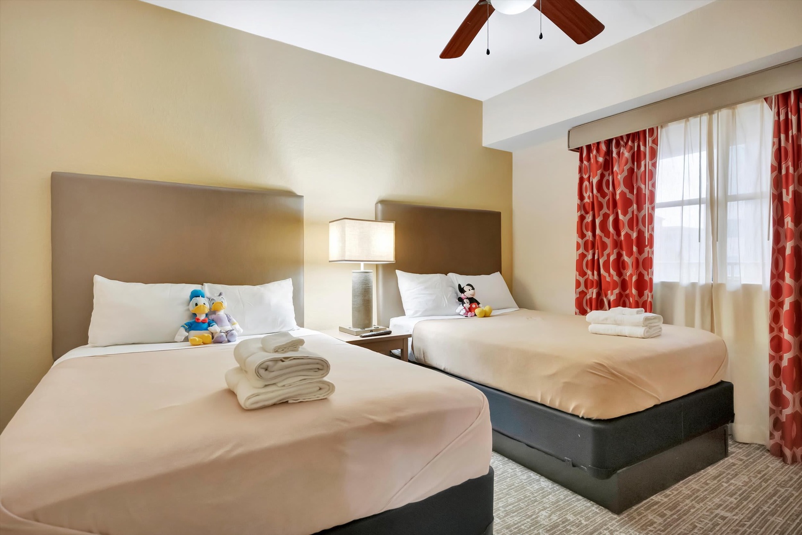 Rest easy in your comfortable bedroom with two plush beds, fresh linens, and a welcoming ceiling fan overhead to keep you cool.