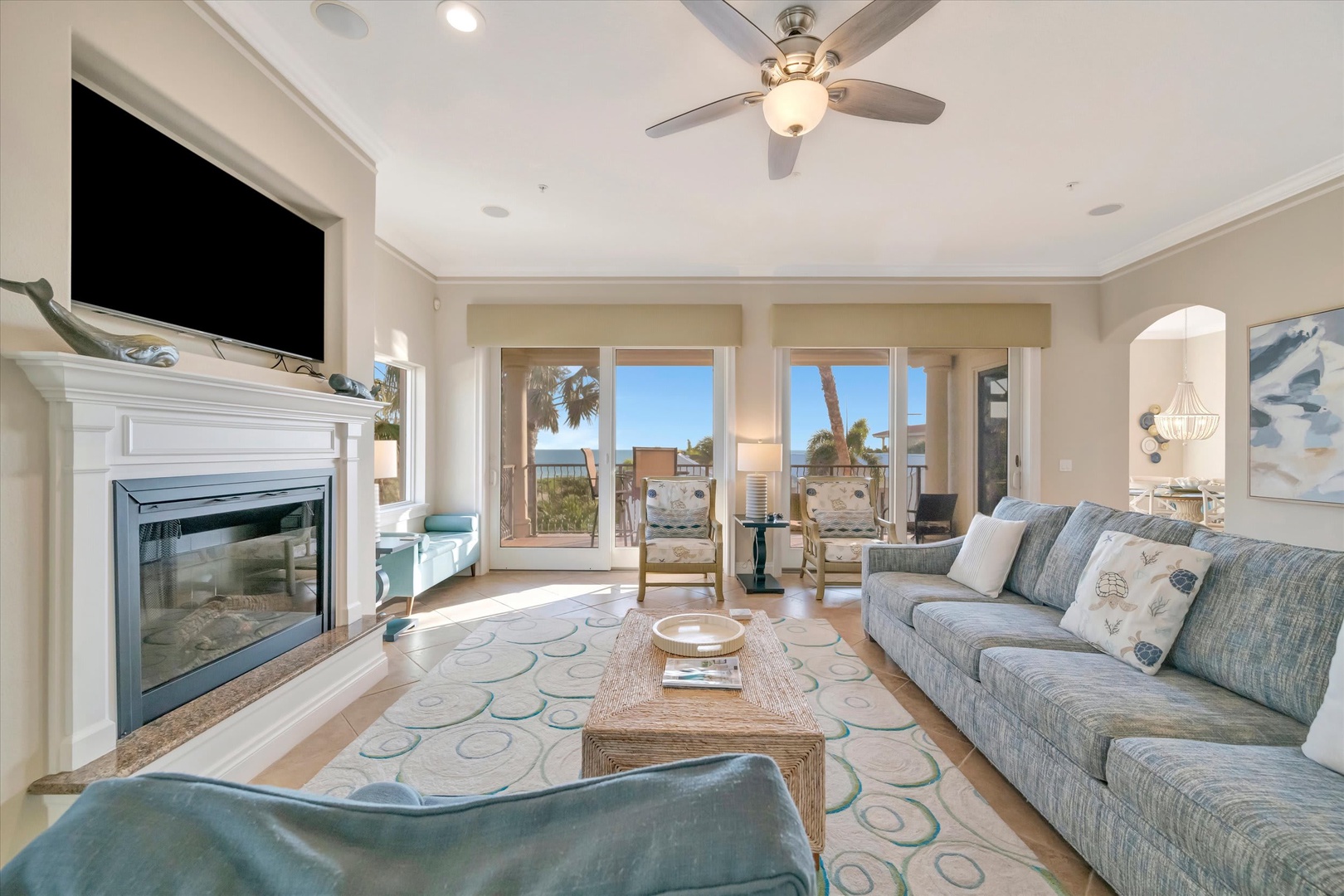 Sink into the plush sofa and let the coastal breeze drift in from your private balcony. The fireplace adds warmth on cooler evenings while ocean views fill your days with endless blue.