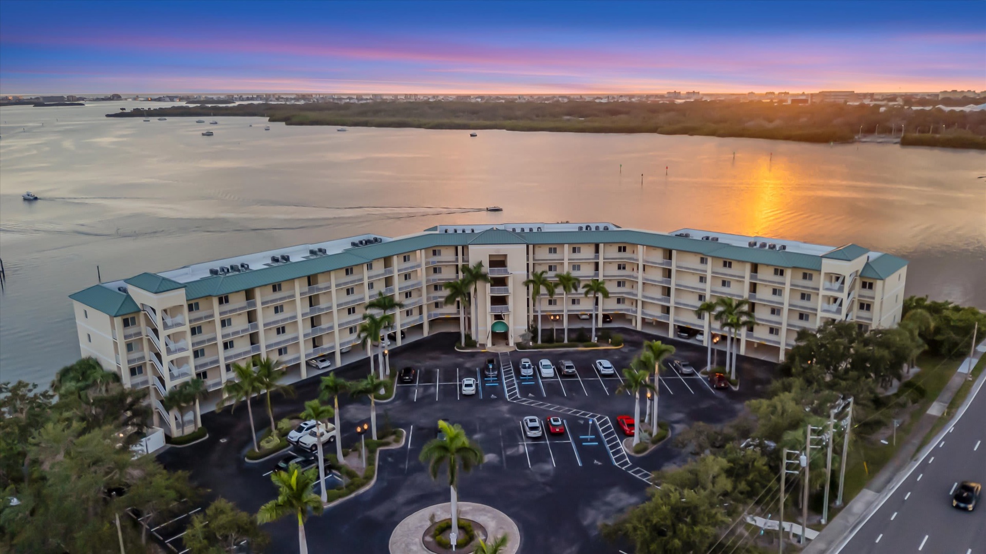 This waterfront property features convenient parking and stunning surroundings. The building sits along calm waters with scenic views of the bay and distant shoreline, making it an ideal base for a peaceful getaway.