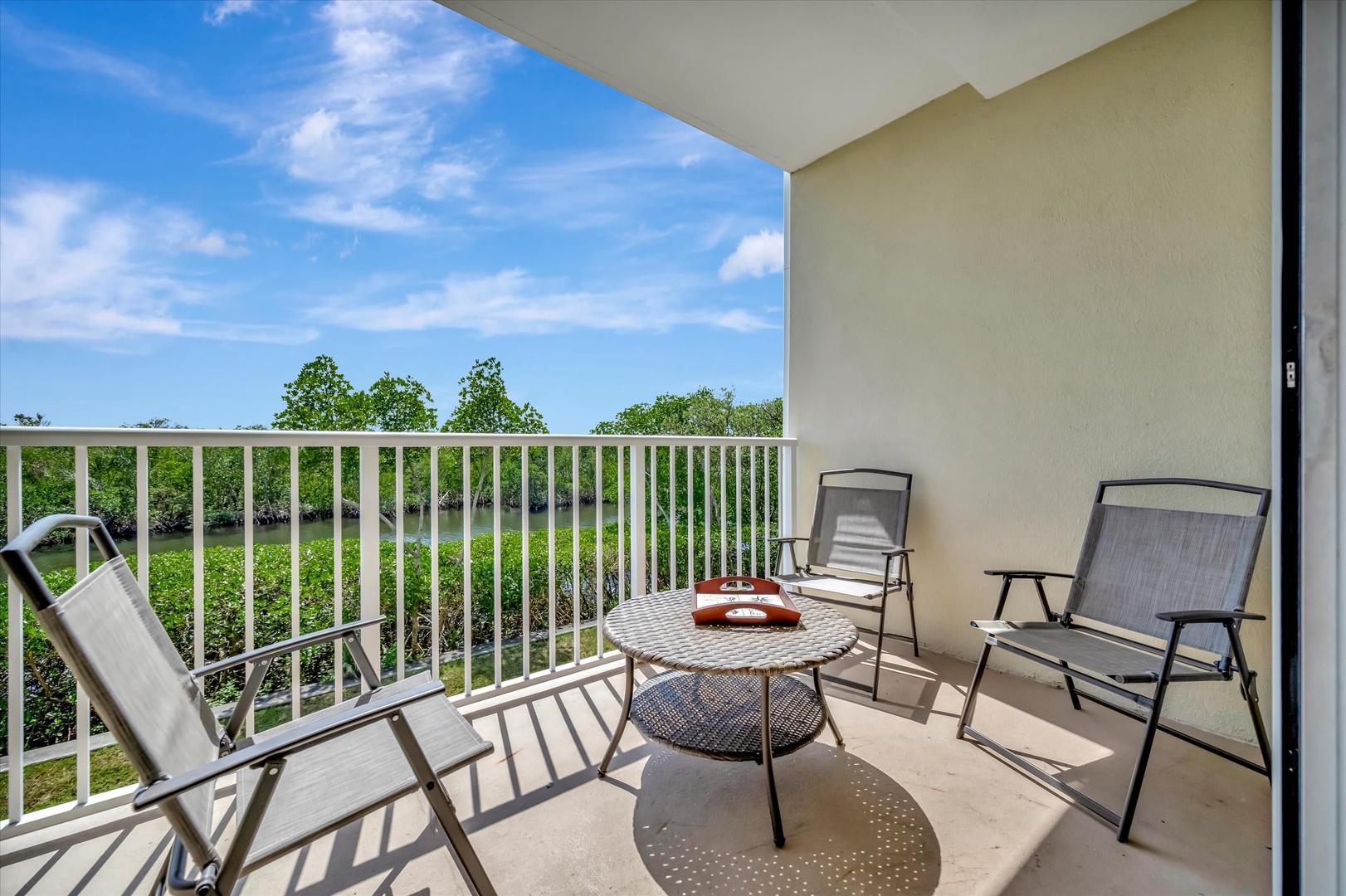 Step onto your private balcony and settle into comfortable seating overlooking peaceful greenery. The perfect spot for your morning coffee or evening wind-down with nature as your backdrop.