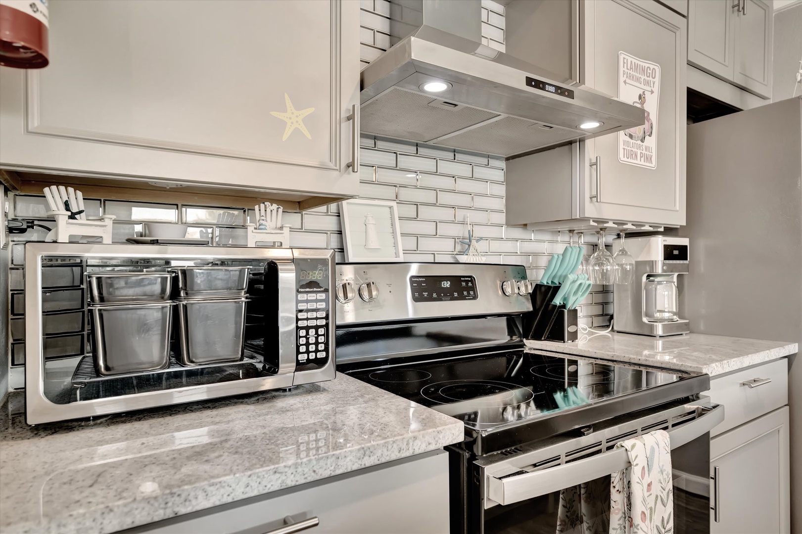 Your fully equipped kitchen features modern stainless appliances, gleaming granite countertops, and beach-inspired coastal touches—ready for preparing everything from morning coffee to memorable vacation meals.