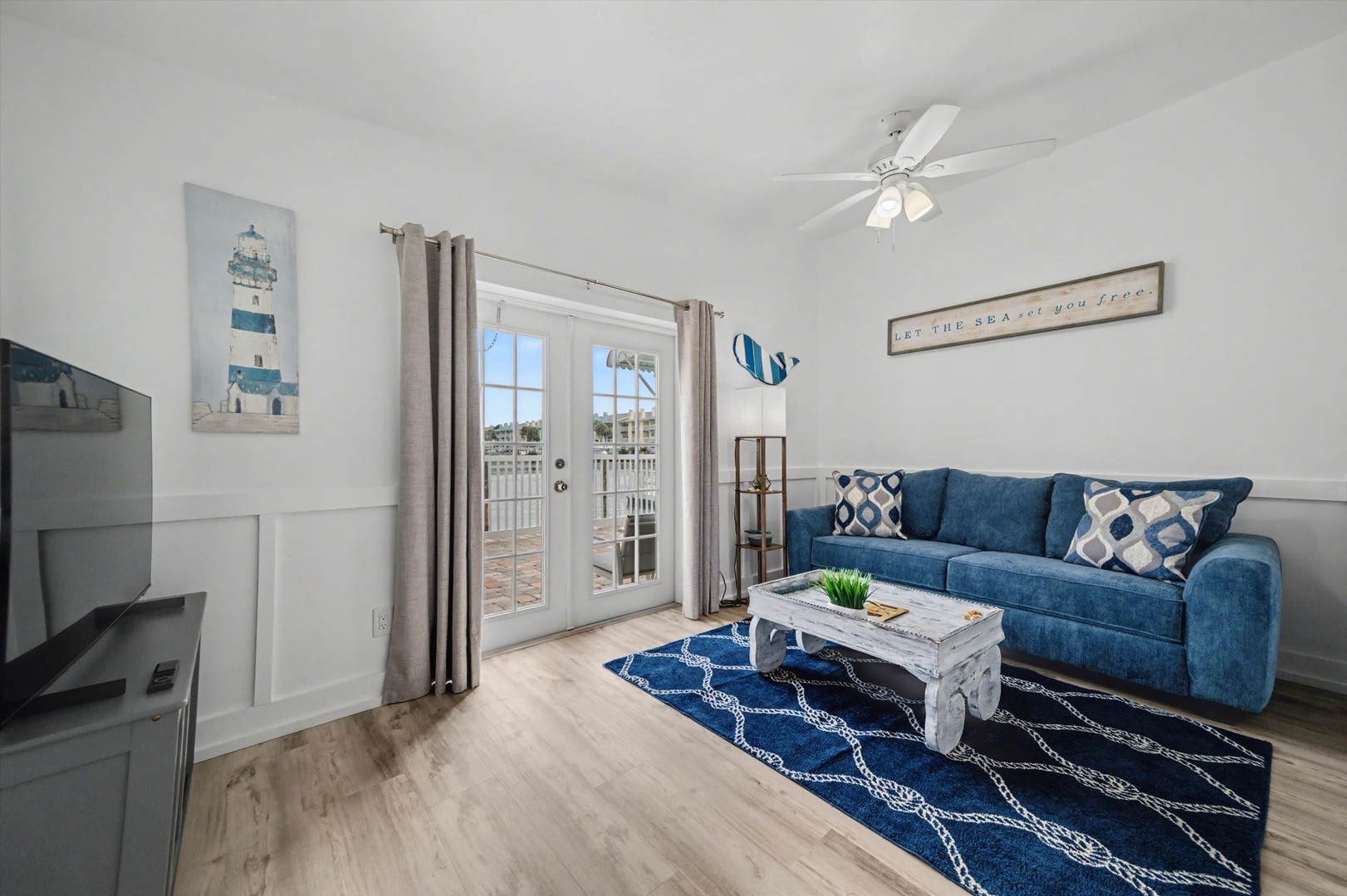 Unwind in your coastal-inspired living room, where soft nautical touches and a plush blue sofa create the perfect spot for your evening relaxation. Step through the glass doors to your private balcony and soak in the sunshine.