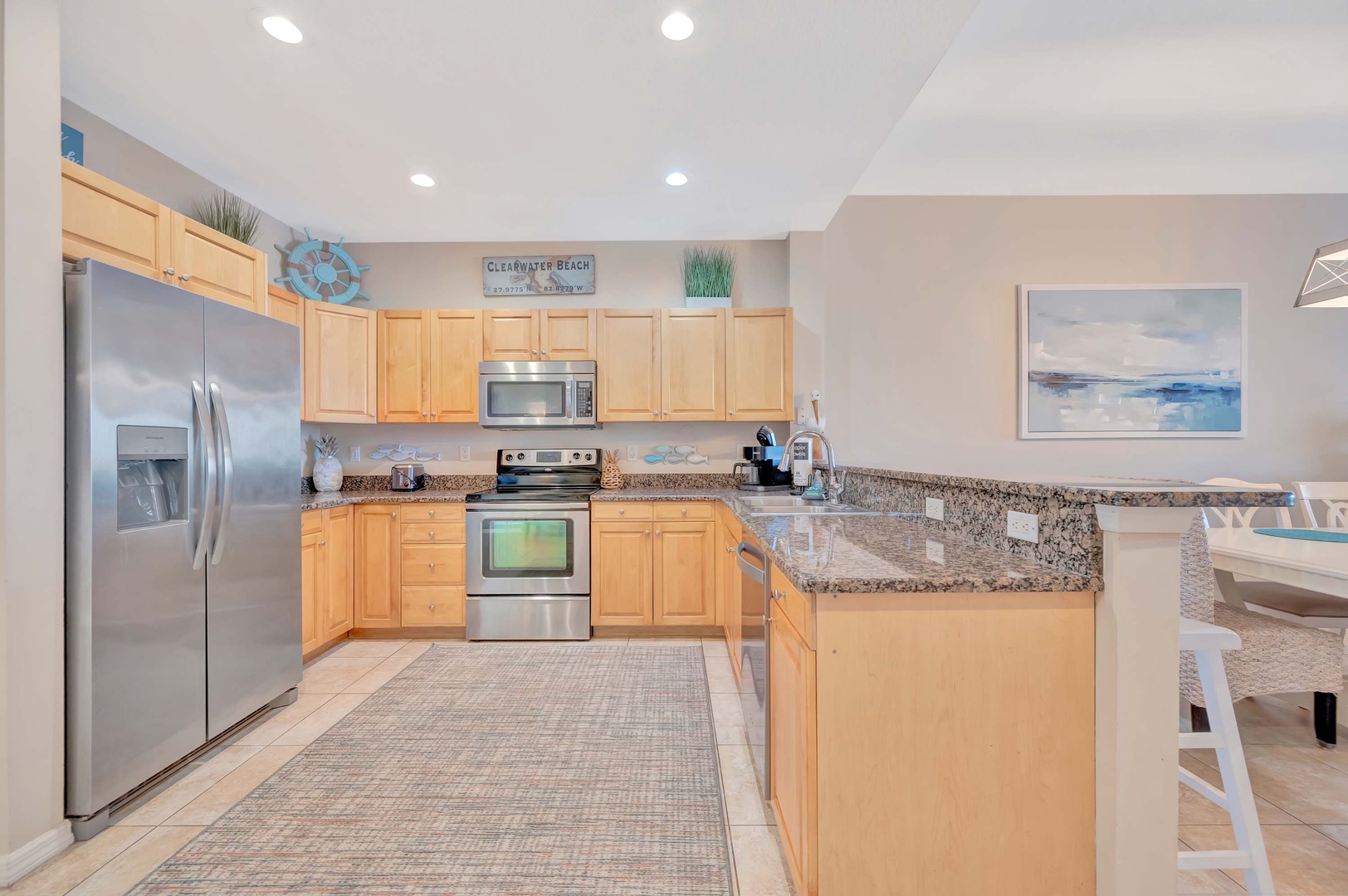 Your fully equipped kitchen features stainless steel appliances, granite countertops, and plenty of space to prepare meals together. Bright and welcoming with coastal touches, it's perfect for morning coffee or evening gatherings.