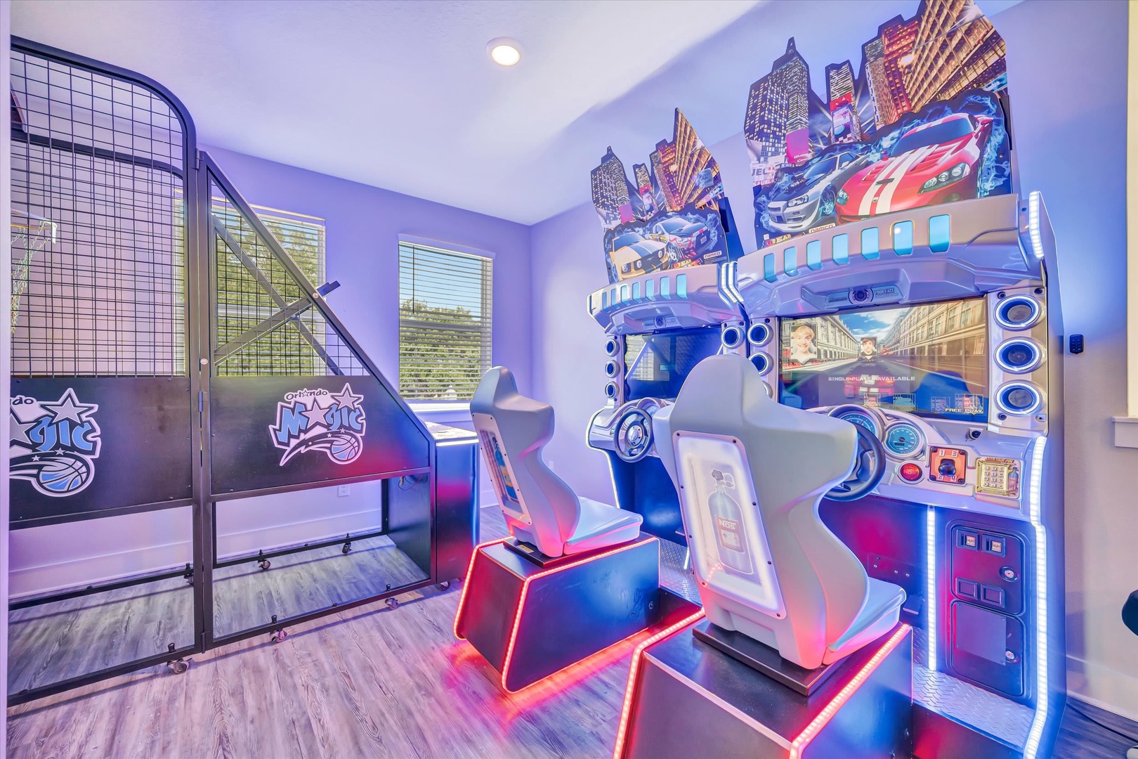 Your kids will love this vibrant themed bedroom with race car simulator seats, bunk beds, and colorful LED lighting throughout—perfect for unforgettable family fun.