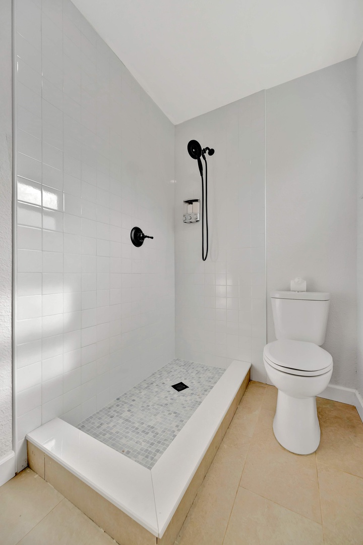 Refresh in your sleek, modern bathroom with a walk-in shower and contemporary fixtures that set a clean, calming tone.