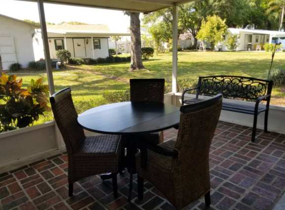 Relax at your own covered patio with garden and lawn views, perfect for morning coffee or evening conversations surrounded by peaceful neighborhood greenery.
