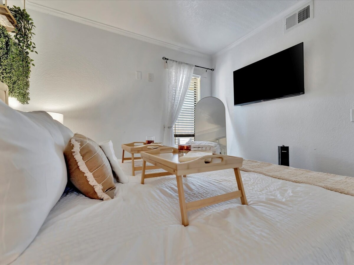 Sink into crisp white linens and enjoy your morning coffee from this charming bed tray. Soft natural light and calming decor create the perfect retreat after a day exploring the area.