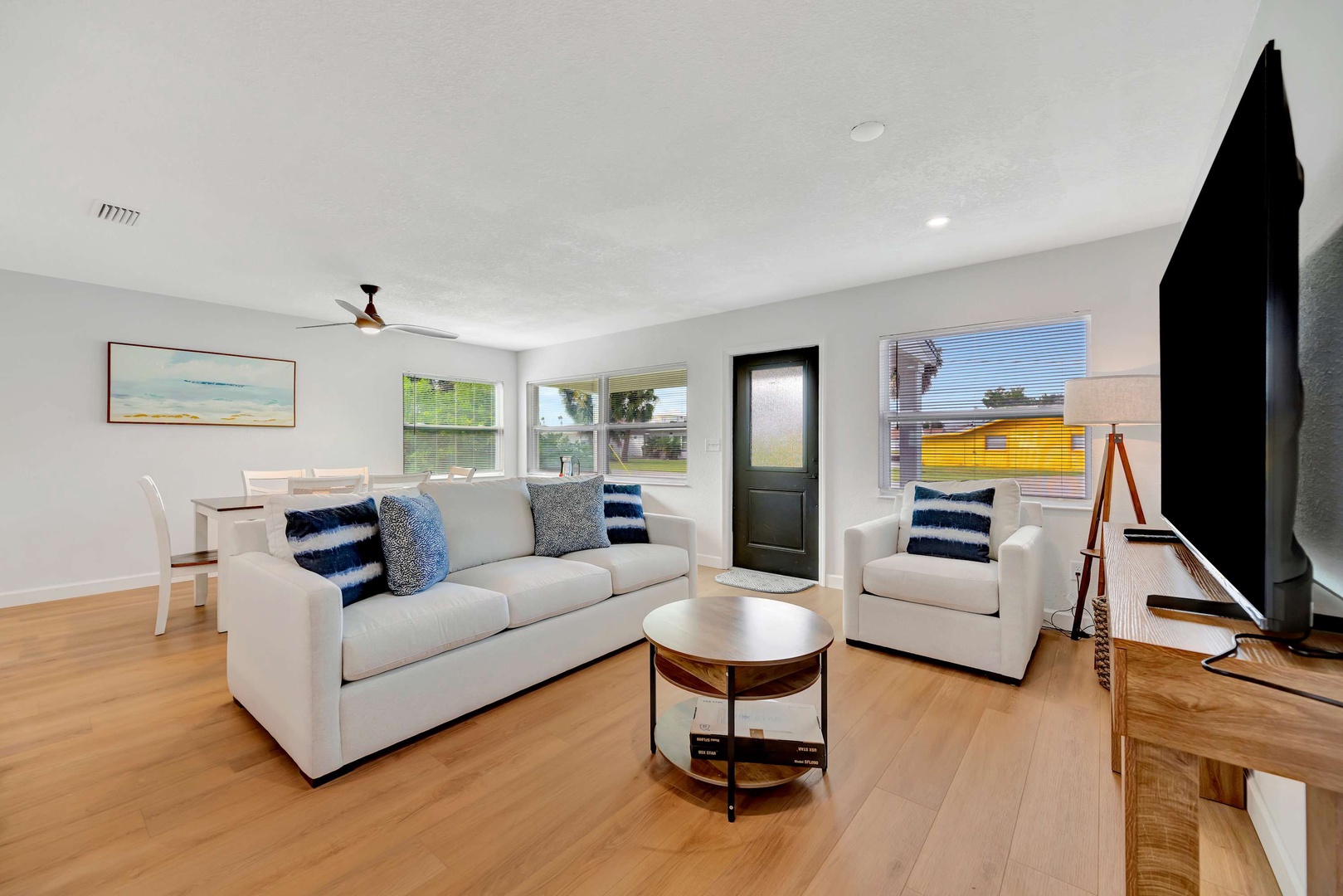 Settle into your bright, open living space with comfortable seating and warm wood floors that invite you to kick off your shoes and unwind after a day of exploring.