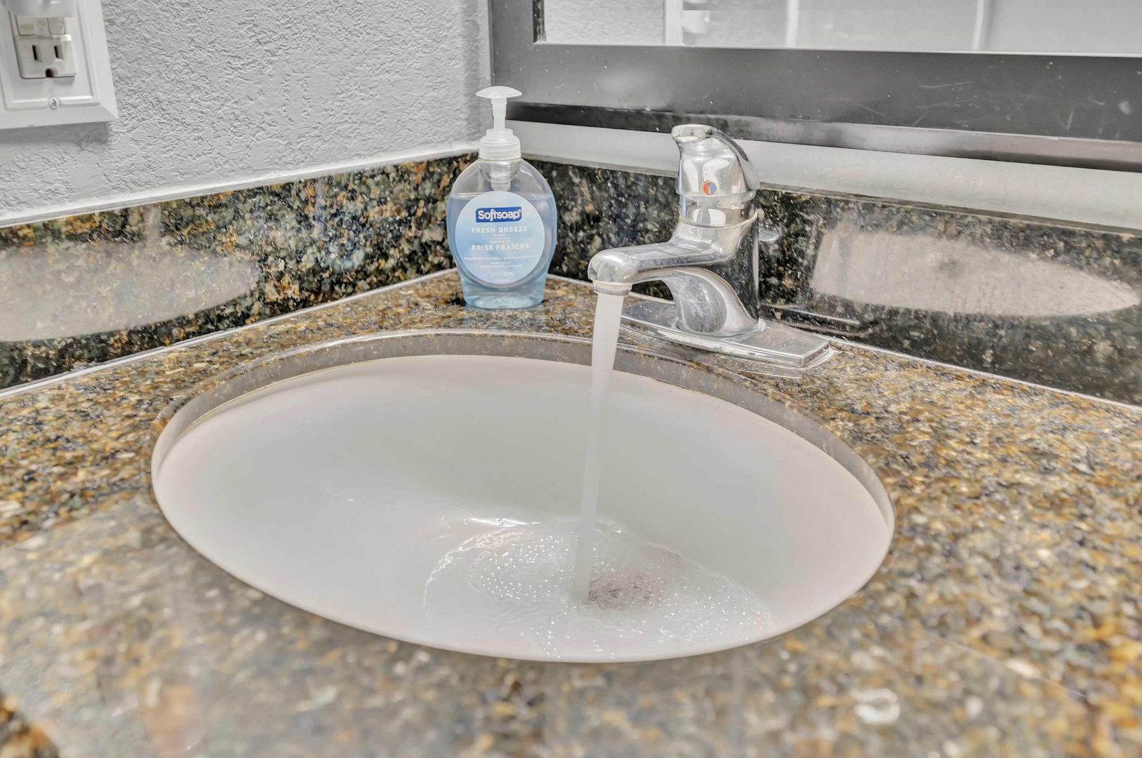 Freshen up at your private vanity, complete with granite counters and thoughtful touches. The running water awaits your morning routine.