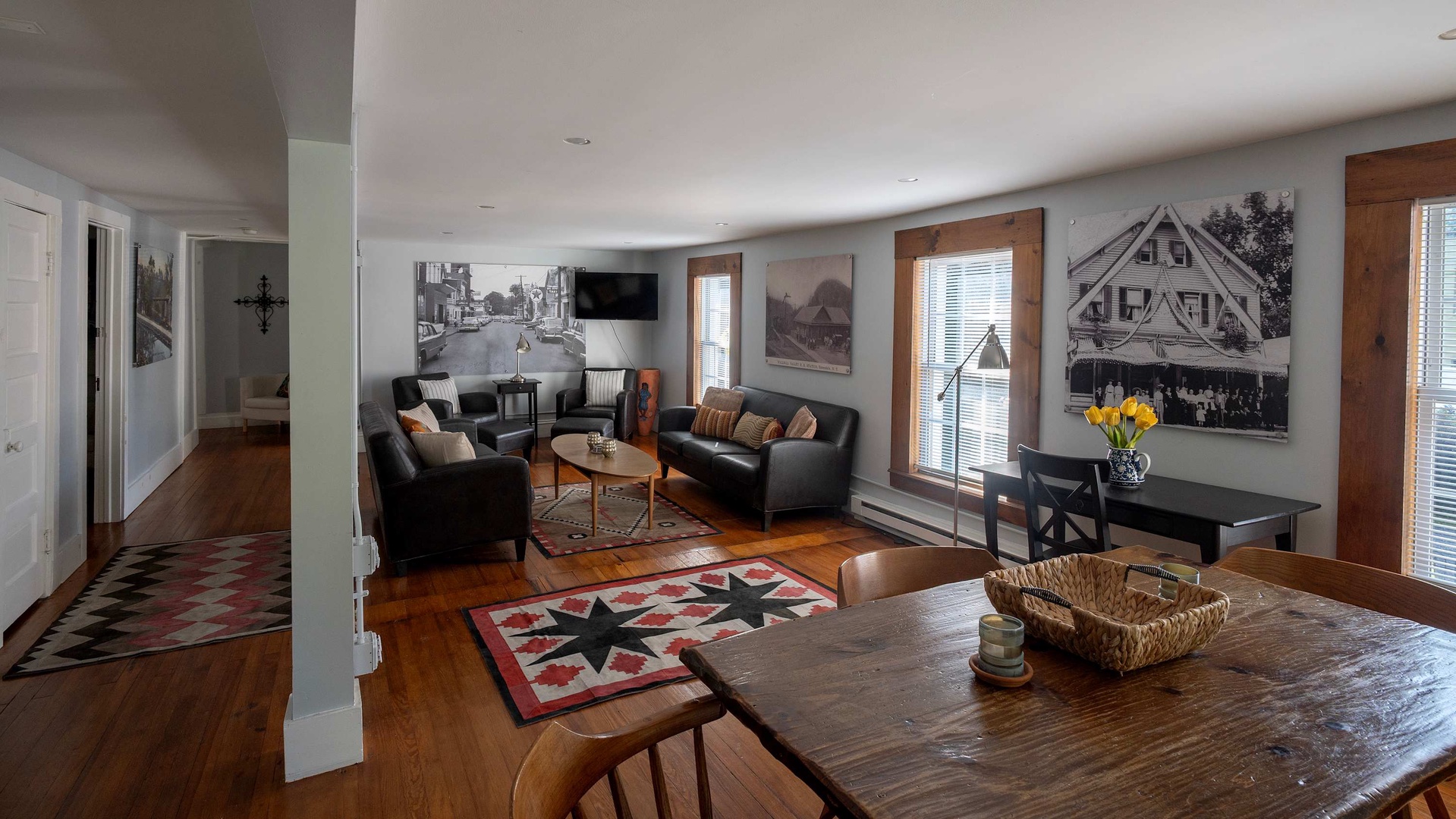 Step into your cozy retreat where vintage charm meets modern comfort. Rich hardwood floors and curated black-and-white photos set the tone, while plush seating invites you to unwind after a day of exploring.