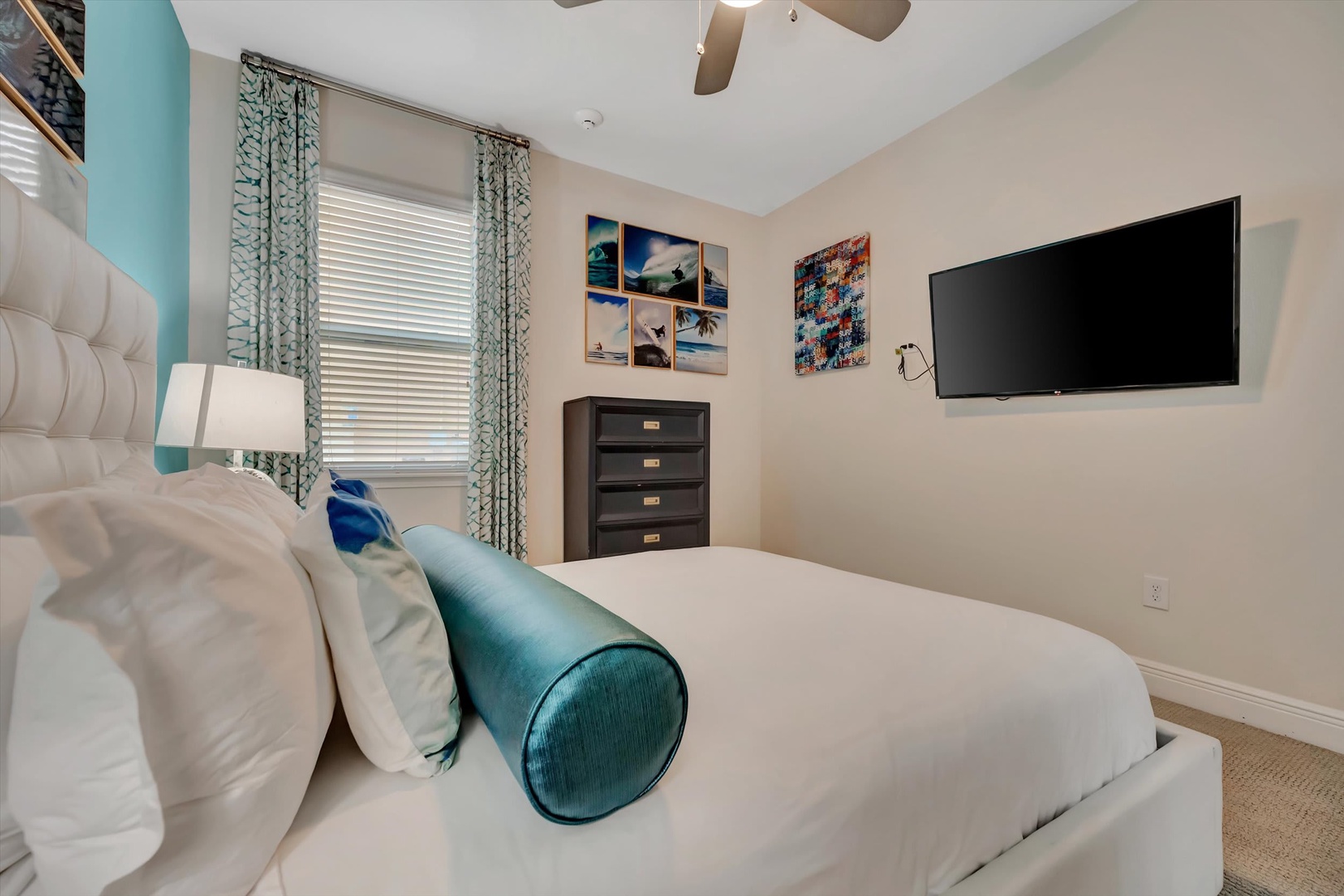 Sink into plush bedding and unwind in your serene bedroom, where soft coastal tones, a ceiling fan, and thoughtful touches create your peaceful retreat after a day of adventure.