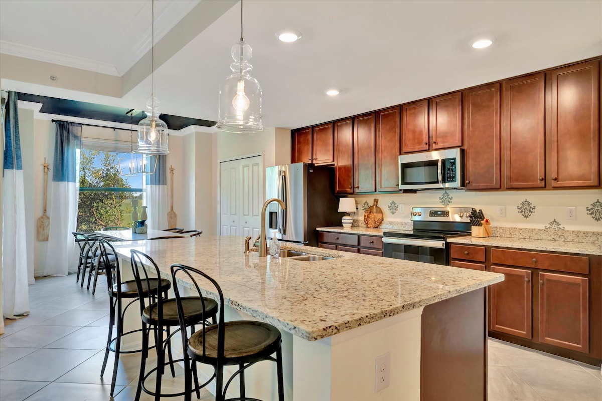 Step into your spacious gourmet kitchen with warm cherry cabinets, granite countertops, and modern appliances. Perfect for family meals or entertaining guests at the breakfast bar.