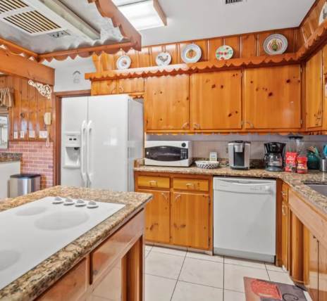 Prepare your favorite meals in this fully equipped kitchen with modern appliances, ample counter space, and plenty of room to gather around the island.