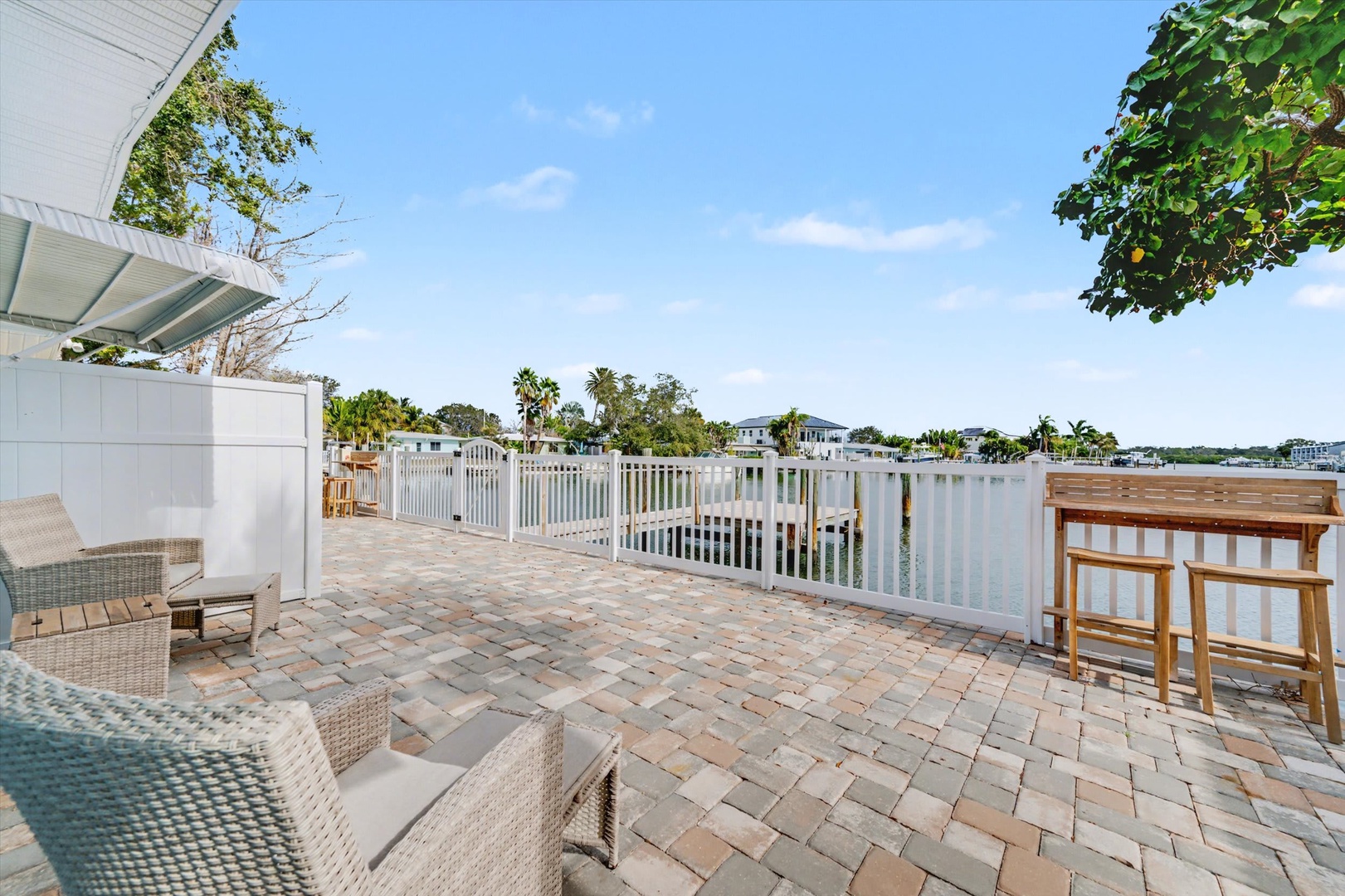 Step onto your private waterfront terrace, where comfortable seating invites you to unwind with sweeping views of the peaceful canal and sunlit Florida skies.