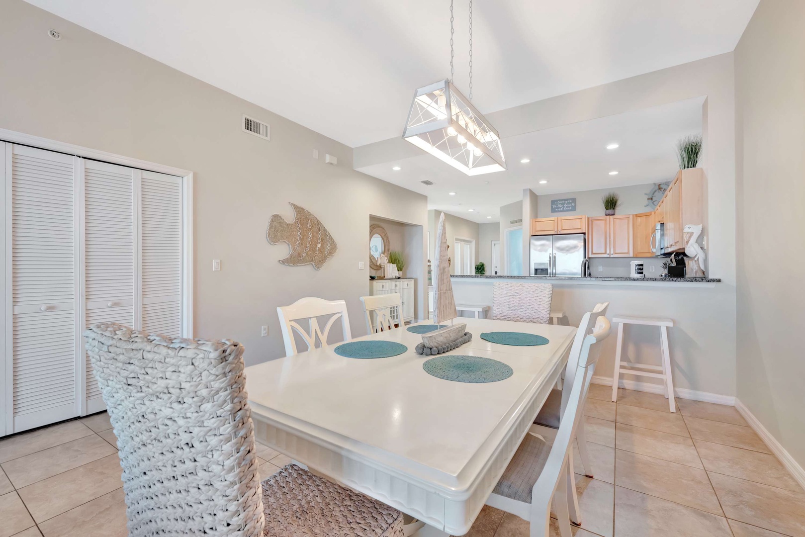 Step into your bright coastal dining space, where beach-inspired touches and vaulted ceilings create an airy, welcoming atmosphere for your family meals and morning coffee.