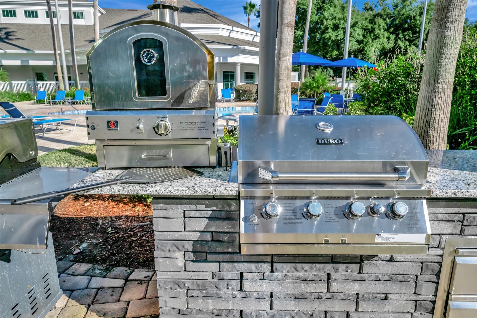 Fire up the grill and pizza oven poolside—your own outdoor kitchen awaits for sunny afternoon cookouts.