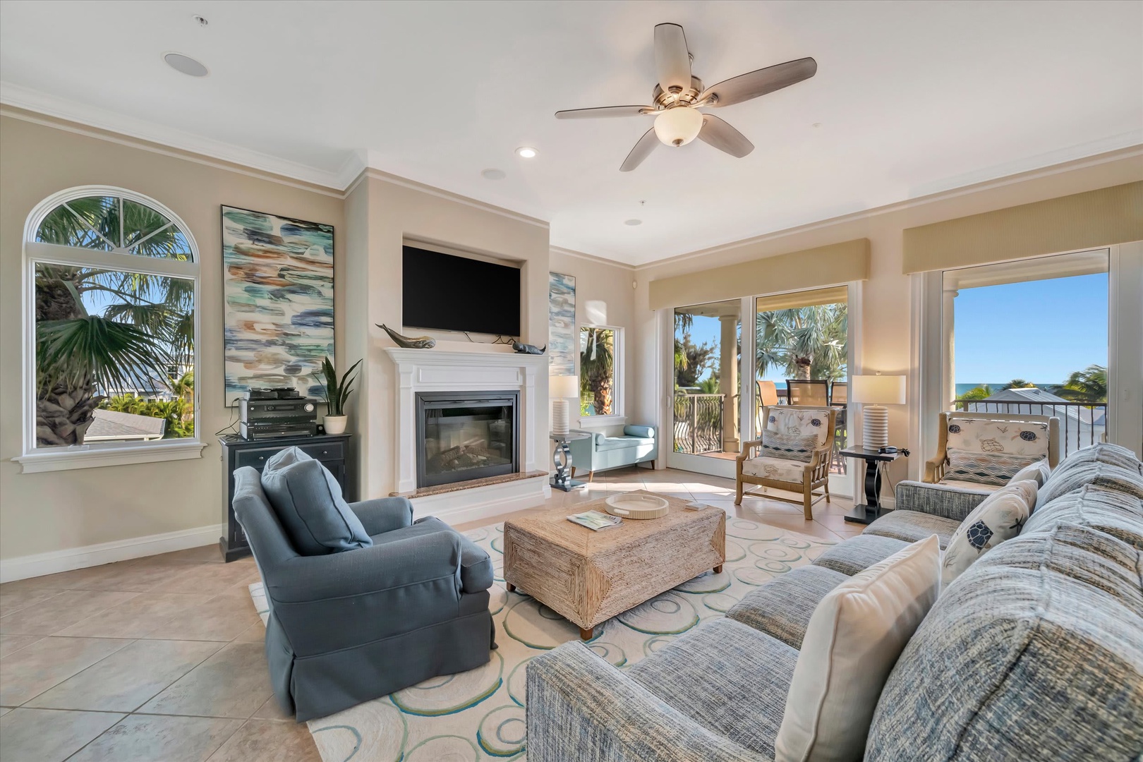 Sink into plush sofas by the fireplace as ocean breezes drift through French doors opening to your private balcony. Natural light floods the room, making your coastal escape feel bright and welcoming.