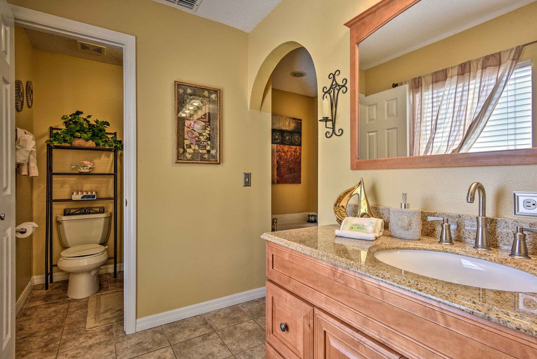 Freshen up in your stylish private bathroom with warm wood cabinetry, granite counters, and a spacious vanity—everything you need for a comfortable stay.