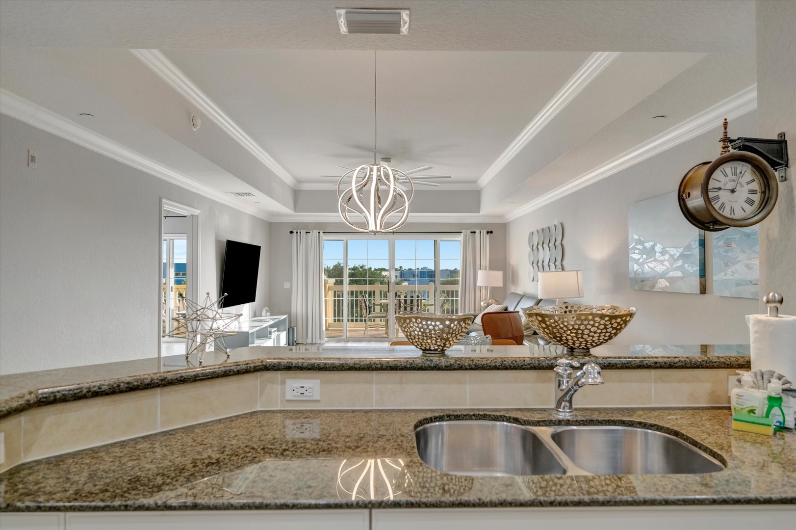 A spacious open-concept layout where kitchen flows seamlessly into living room, with natural light streaming through balcony doors. Your perfect retreat for coastal relaxation.