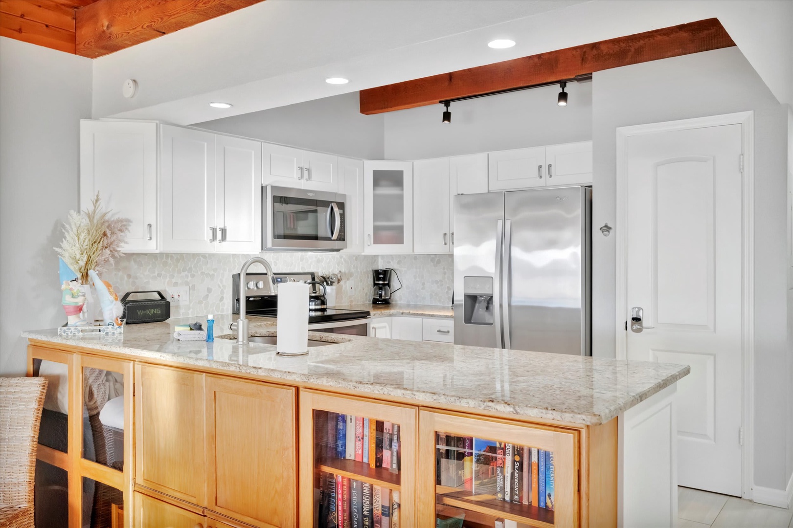 Step into your fully-equipped kitchen where gleaming granite countertops and stainless steel appliances make meal prep a breeze. Natural wood accents and vaulted ceilings create a bright, welcoming space for gathering.
