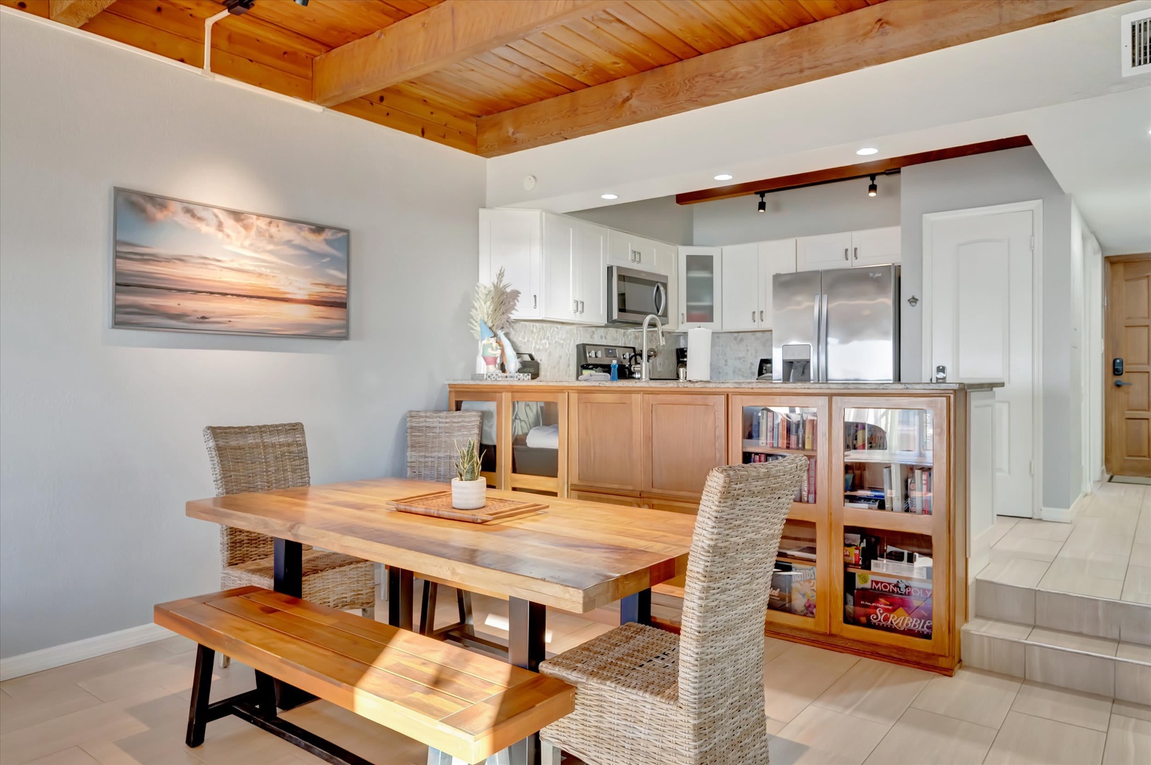 Gather around the dining table under warm wood ceilings, with your fully equipped kitchen just steps away and thoughtful shelving for books and games to enjoy together.
