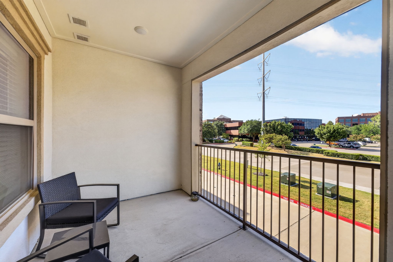 A private balcony with seating offers views of the surrounding neighborhood, perfect for your morning coffee or evening wind-down.