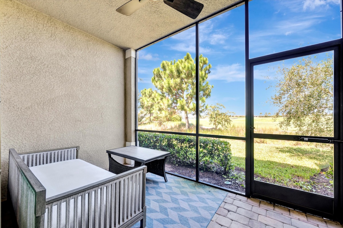 Step onto your private screened patio and enjoy peaceful garden views with comfortable seating for morning coffee or evening relaxation.